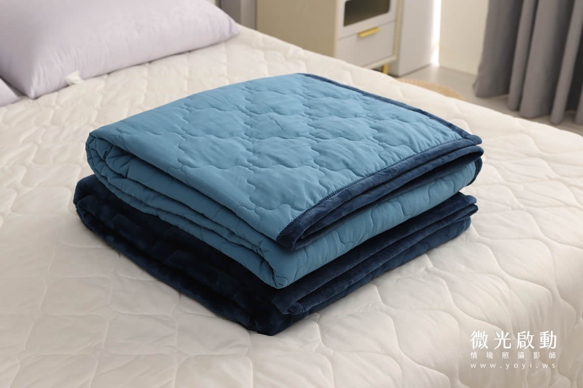 藍綠色與深藍色雙面毛毯，絎縫設計，特寫細節，強調商品質感與紋理